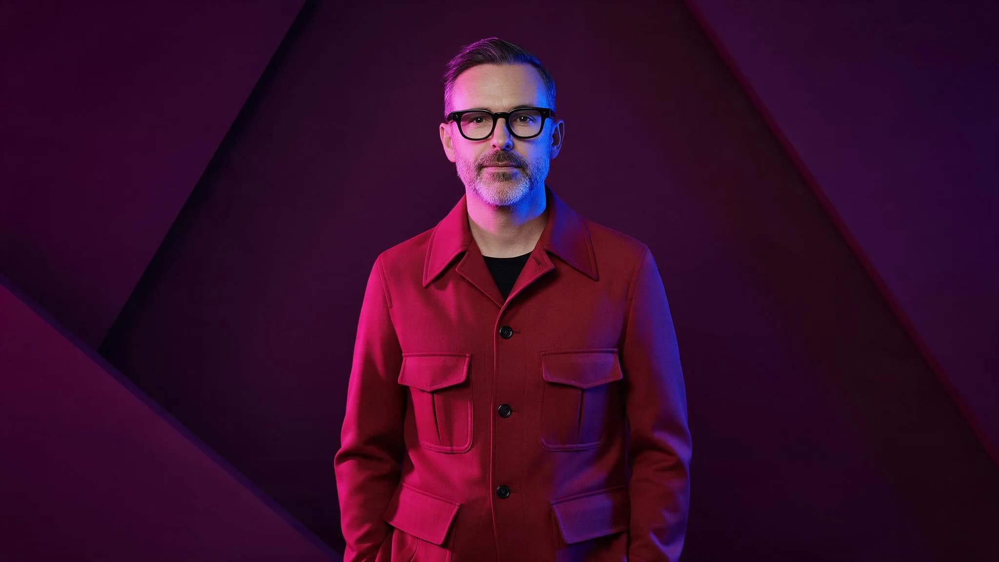 Fictional adult creative director in color-block lighting illustrating a text-to-image prompt